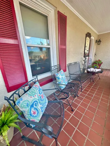 a bedroom with furniture and a large window
