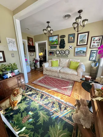 a living room with furniture fireplace and a window