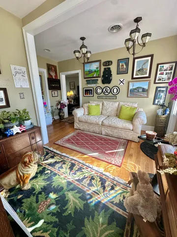 a living room with furniture fireplace and a window