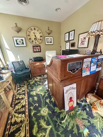 a kitchen with a table chairs and a wooden floor