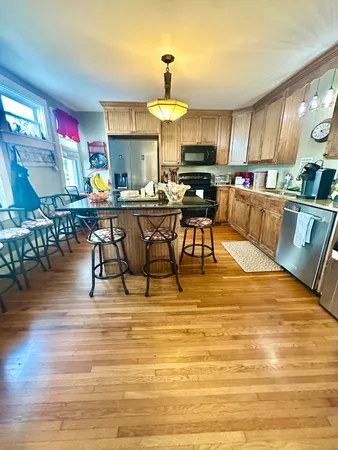 a view of entryway livingroom and hall with wooden floor