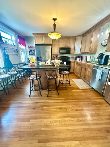 a view of entryway livingroom and hall with wooden floor