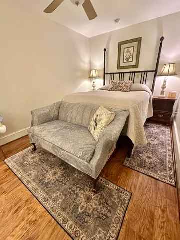 a spacious bedroom with a bed and a window