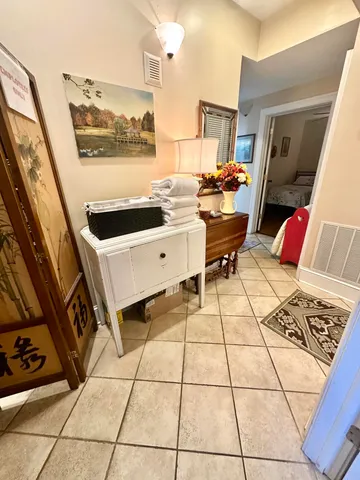 a living room filled with furniture and a floor to ceiling window