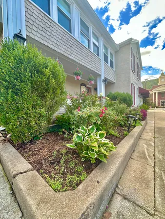 a living room with patio furniture and painting on the wall