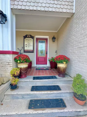 a room with furniture and paintings on wall