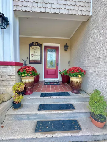 a room with furniture and paintings on wall