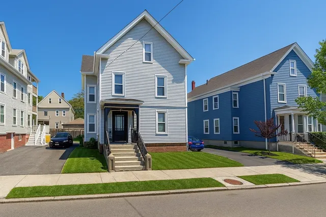 a front view of a house with a yard