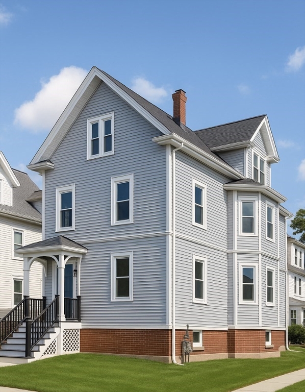 21 Brimblecom Street, Unit 3 Lynn, MA 01902 - Photo 2 of 13 a front view of a house with a yard