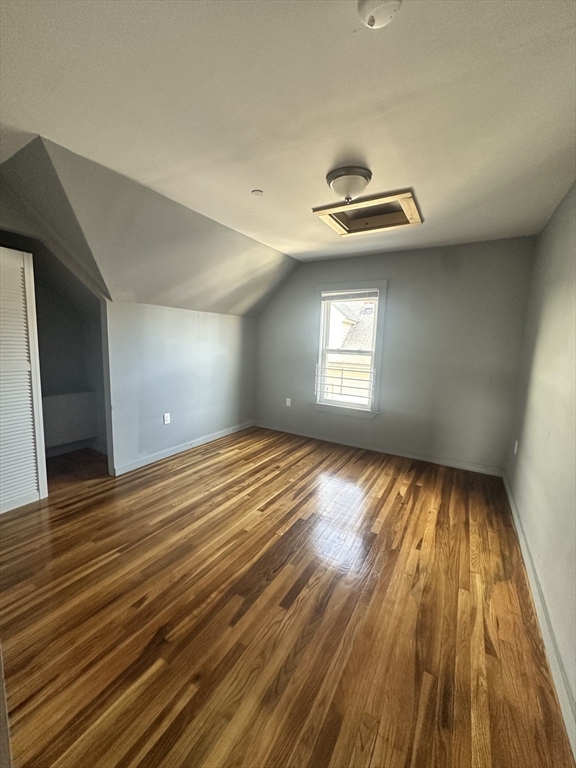 21 Brimblecom Street, Unit 3 Lynn, MA 01902 - Photo 3 of 13 wooden floor in an empty room with a window