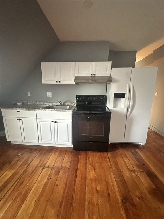 21 Brimblecom Street, Unit 3 Lynn, MA 01902 - Photo 5 of 13 a kitchen with wooden floors and appliances