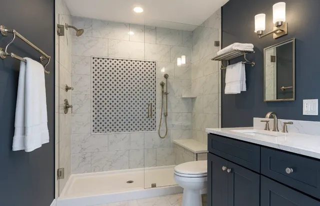 a bathroom with a sink a toilet and shower