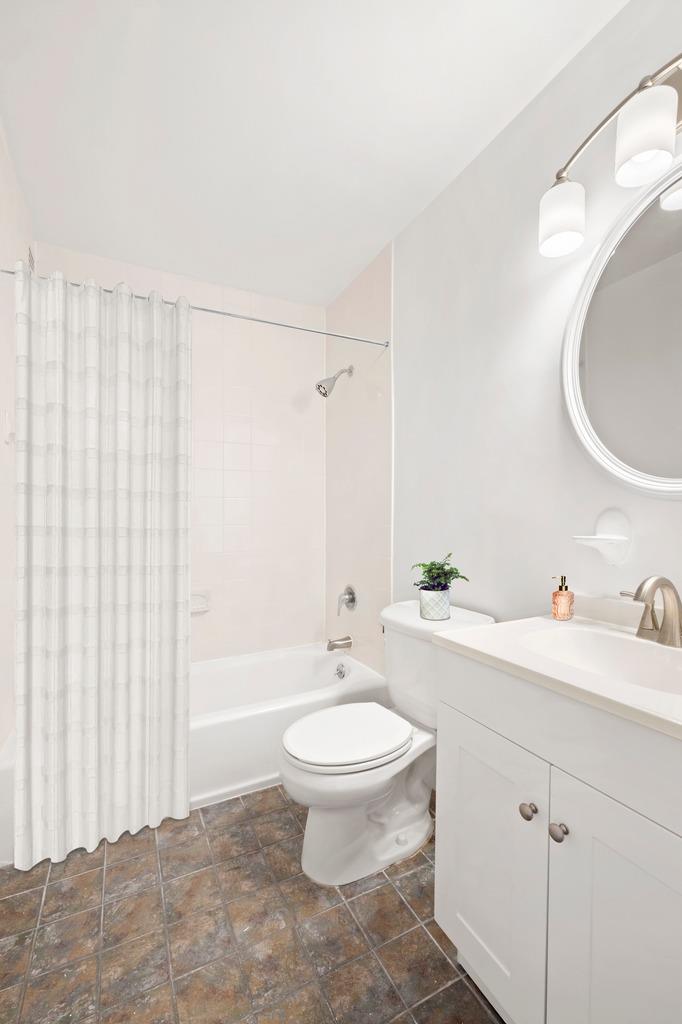 301 East 79th Street, Unit 15M Manhattan, NY 10075 - Photo 5 of 8 a bathroom with a toilet a sink and mirror