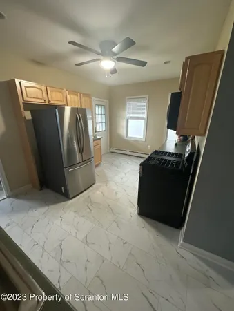 a living room with a bed furniture and a large window