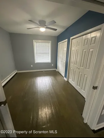 a view of hallway with wooden floor