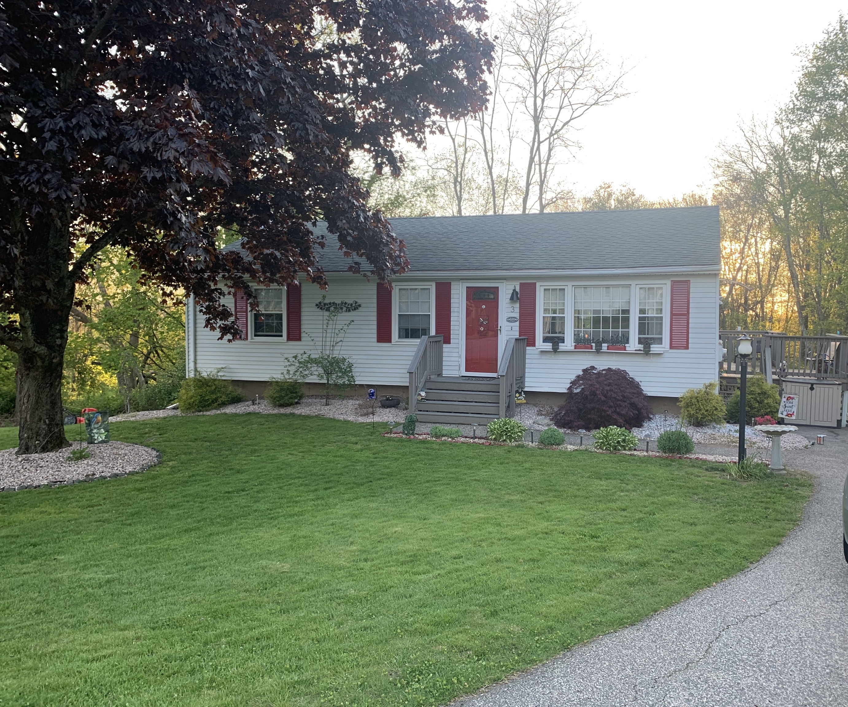 a front view of house with yard and green space