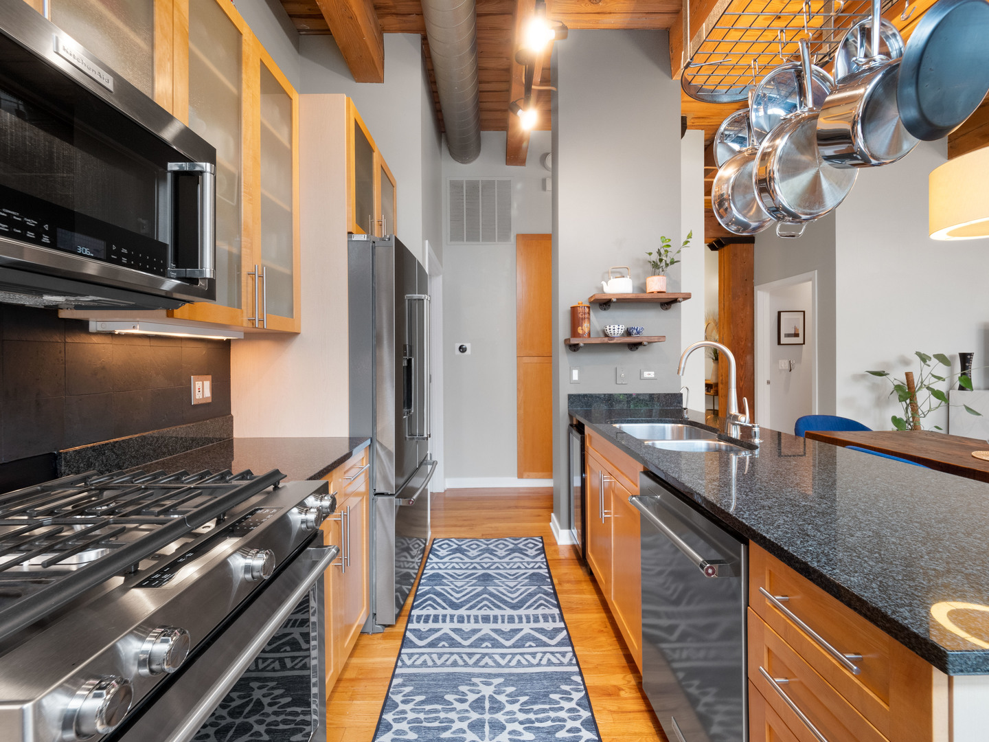 1750 North Wolcott Avenue, Unit 104 Chicago, IL 60622 - Photo 11 of 32 a kitchen with granite countertop a sink and a stove