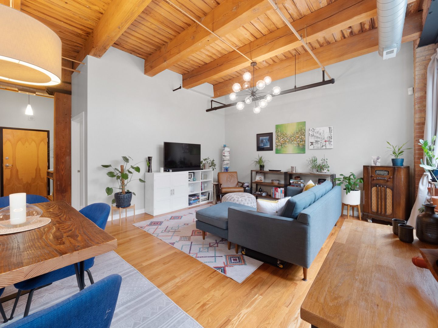 1750 North Wolcott Avenue, Unit 104 Chicago, IL 60622 - Photo 5 of 32 a living room with furniture a flat screen tv and a table