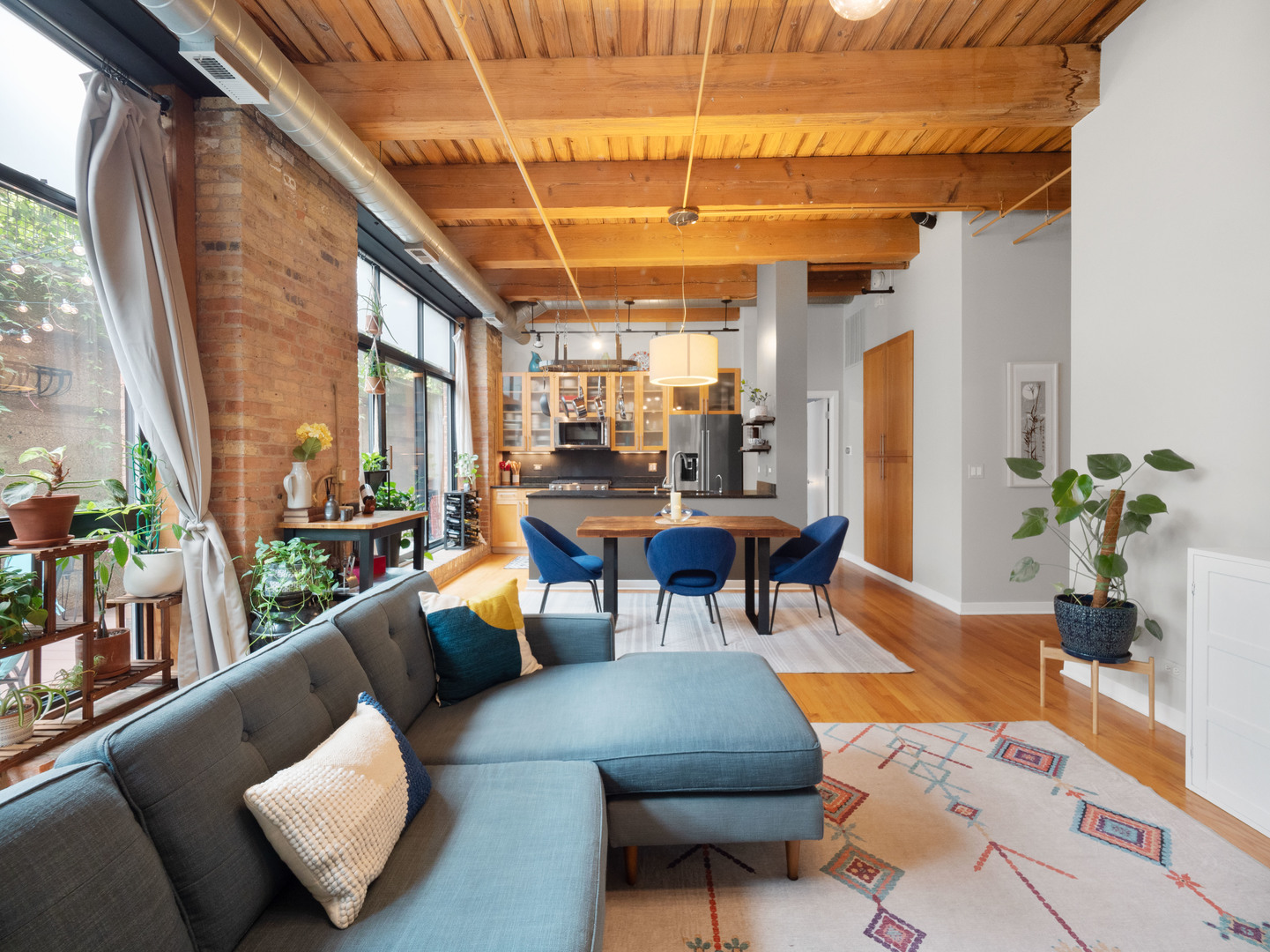 1750 North Wolcott Avenue, Unit 104 Chicago, IL 60622 - Photo 8 of 32 a living room with furniture and a chandelier