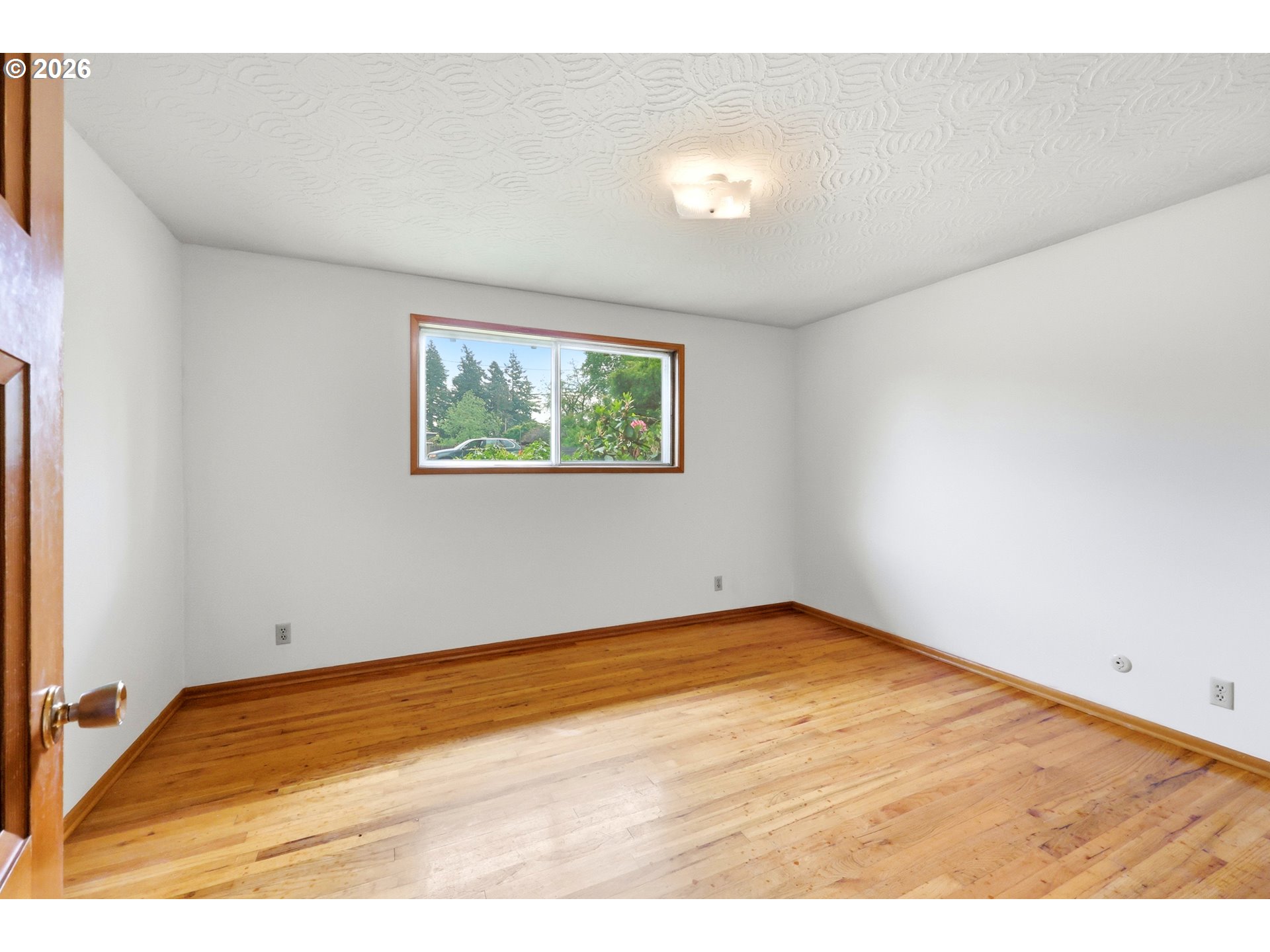 3003 Southeast 162nd Avenue Portland, OR 97236 - Photo 16 of 41 an empty room with wooden floor and windows