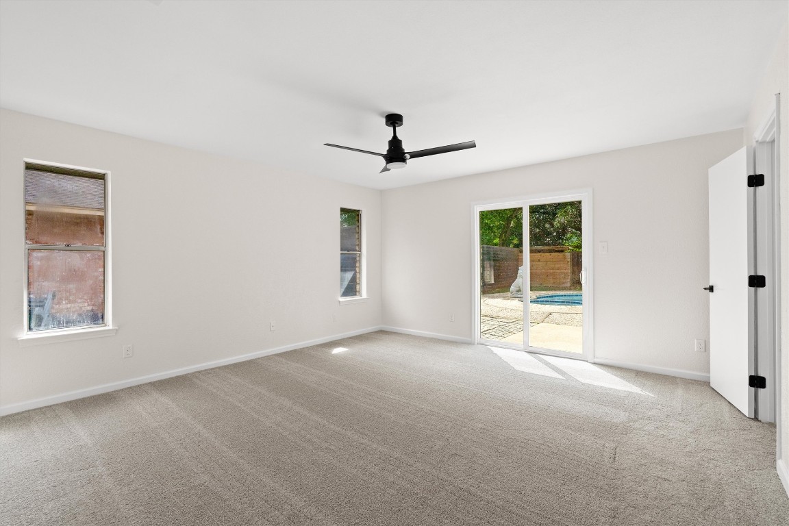 7008 Beckett Road Austin, TX 78749 - Photo 13 of 23 Empty room with carpet floors and ceiling fan