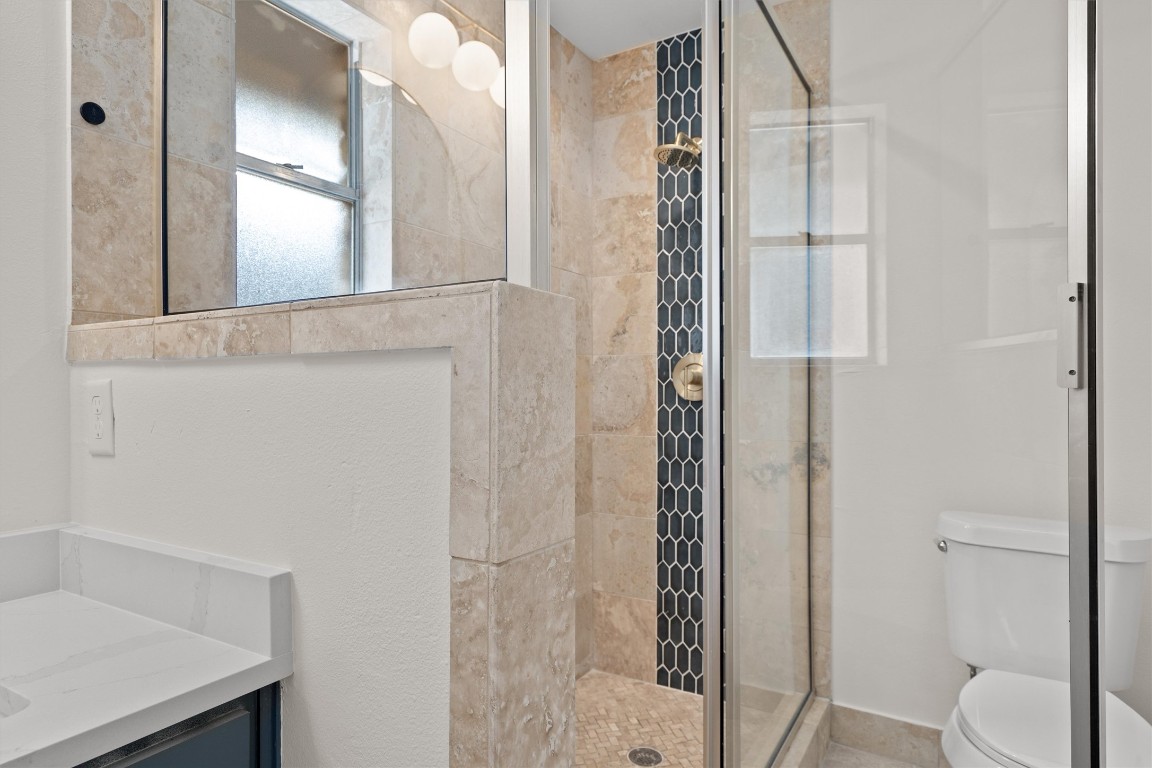 7008 Beckett Road Austin, TX 78749 - Photo 15 of 23 Bathroom featuring vanity and a shower stall