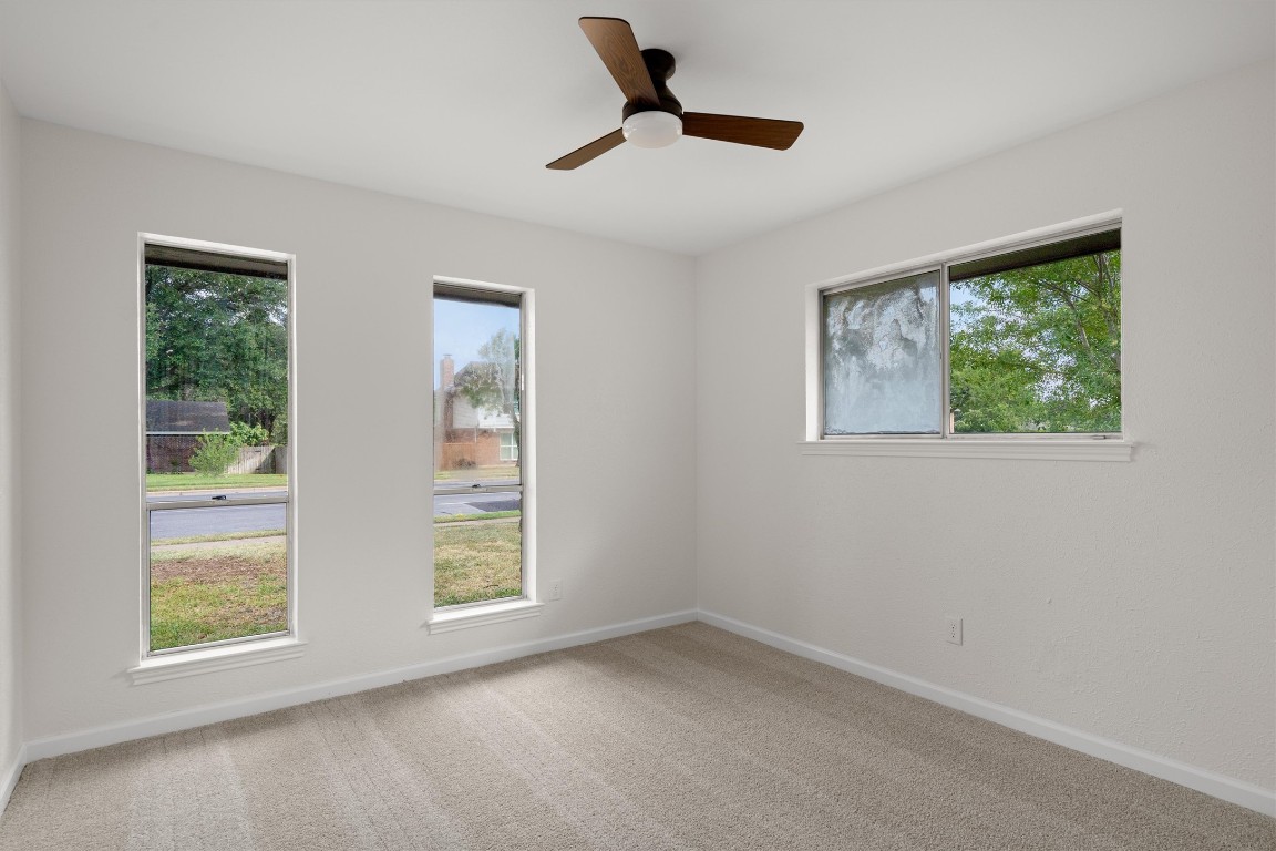 7008 Beckett Road Austin, TX 78749 - Photo 17 of 23 Spare room with light carpet and a ceiling fan