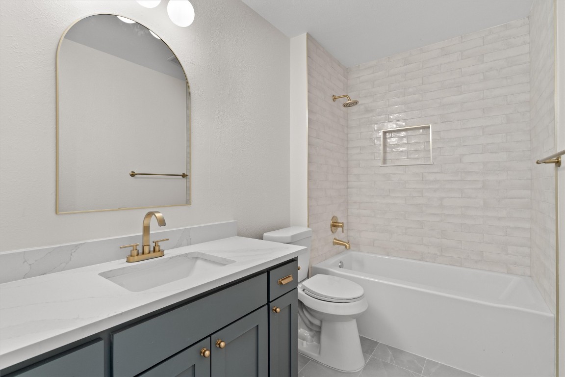 7008 Beckett Road Austin, TX 78749 - Photo 20 of 23 Bathroom with shower combination, vanity, and light tile patterned flooring