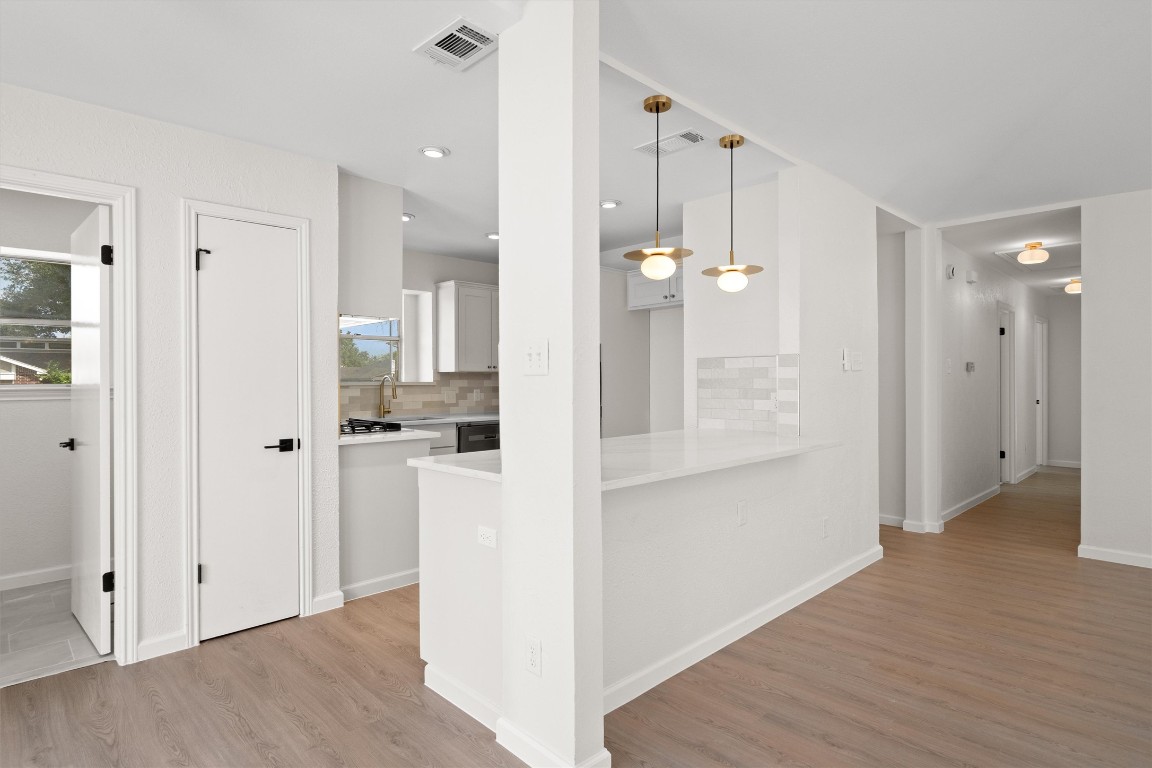 7008 Beckett Road Austin, TX 78749 - Photo 8 of 23 Hallway with light wood-style floors and recessed lighting