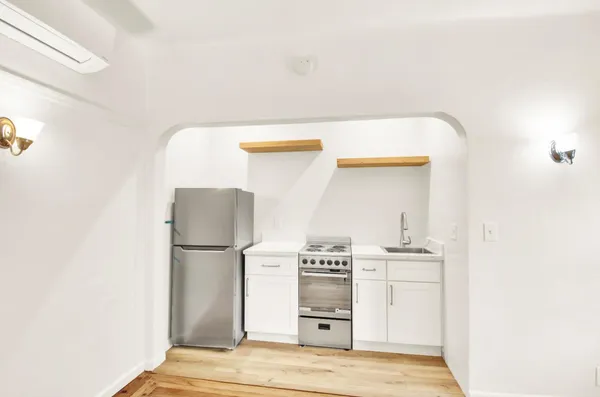 a kitchen with a stove and a refrigerator