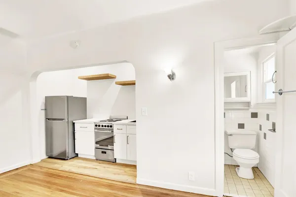 a bathroom with a toilet and a mirror