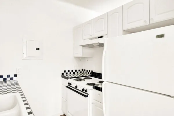 a white cabinet with black and white cabinets