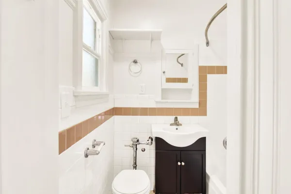 a bathroom with a sink a toilet and a mirror