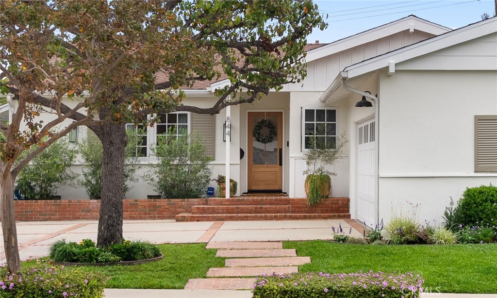 a front view of a house with garden