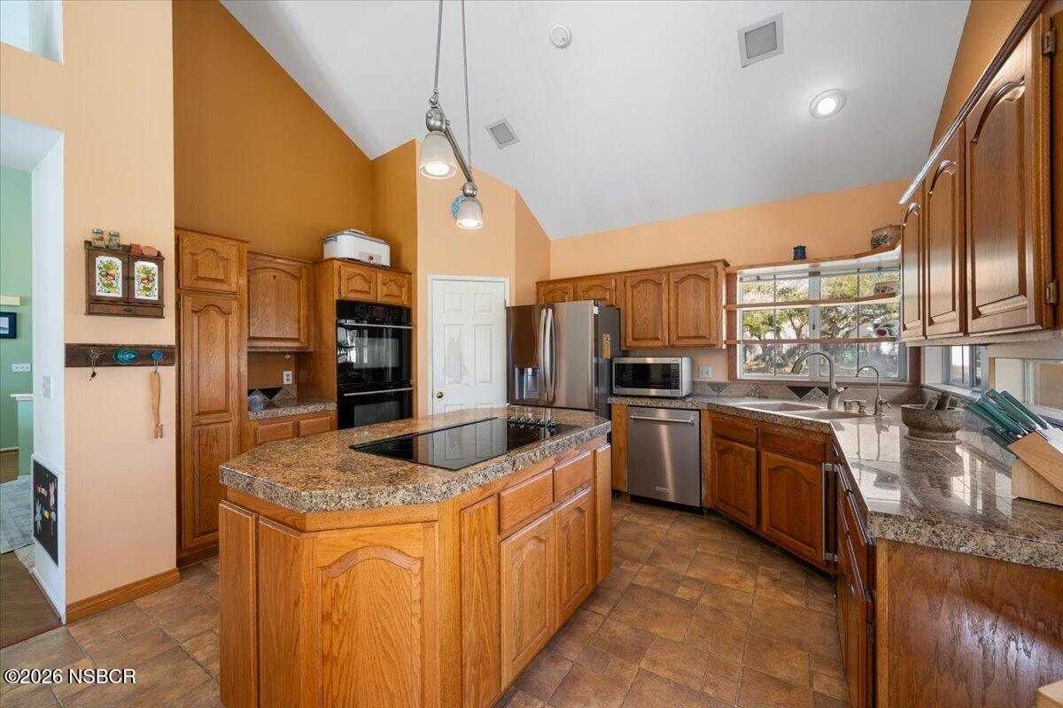 892 Onstott Road Lompoc, CA 93436 - Photo 11 of 40 a kitchen with stainless steel appliances granite countertop a sink a stove and refrigerator
