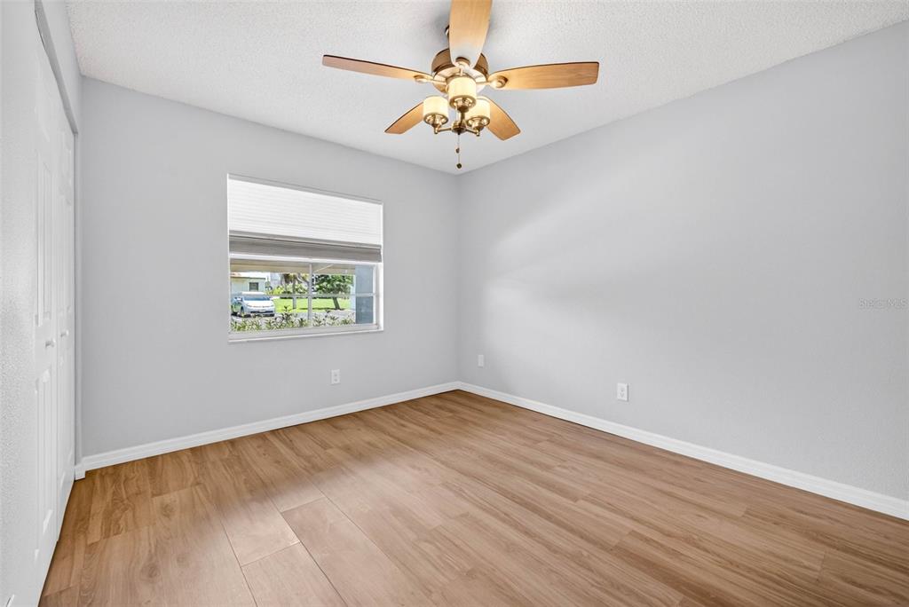 5197 Silent Loop, Unit 124 New Port Richey, FL 34652 - Photo 25 of 55 an empty room with a window and a fan
