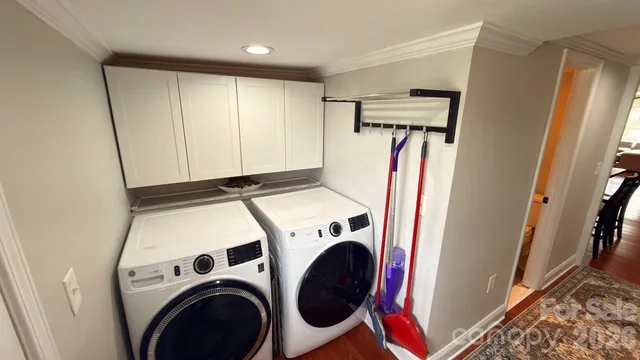 a view of walk in closet with clothes