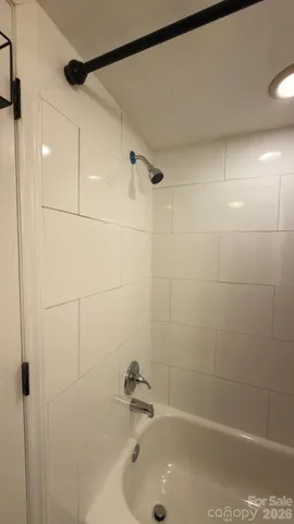 a kitchen with stainless steel appliances granite countertop a refrigerator and a dining table