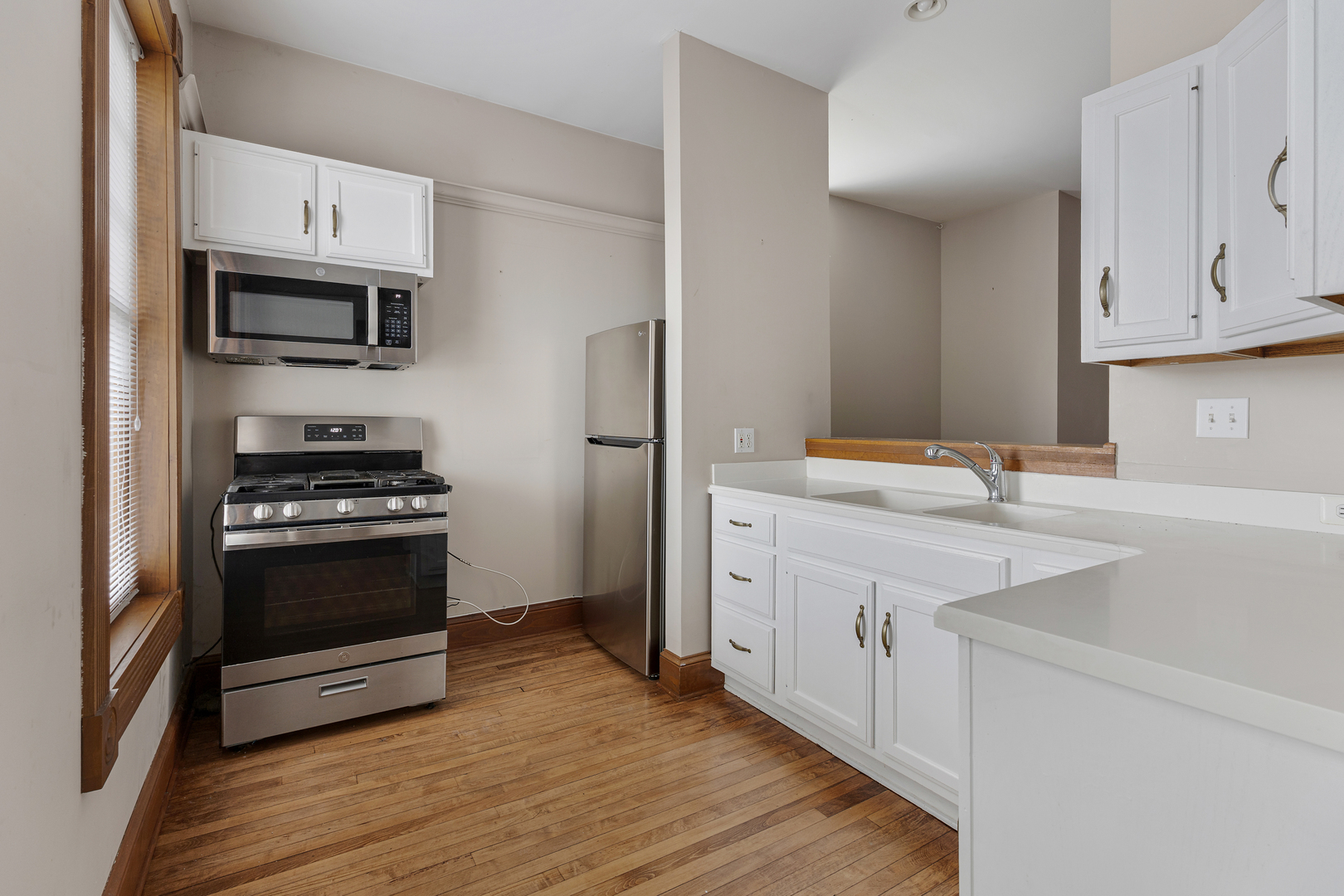 222 West Main Street, Unit A St. Charles, IL 60174 - Photo 7 of 17 a kitchen with stainless steel appliances white cabinets and a sink