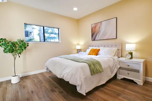 a bedroom with a bed and a potted plant