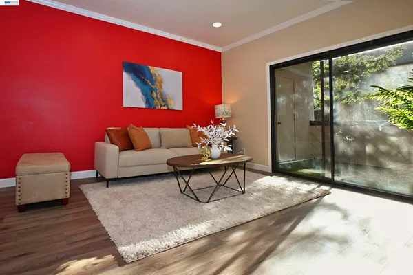 a living room with furniture a lamp and a potted plant