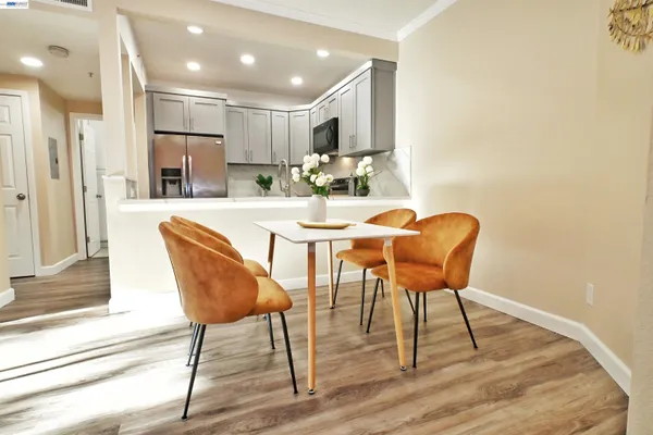 a view of a dining room with furniture and wooden floor