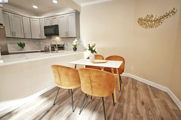 a dining room with furniture and a flat screen tv