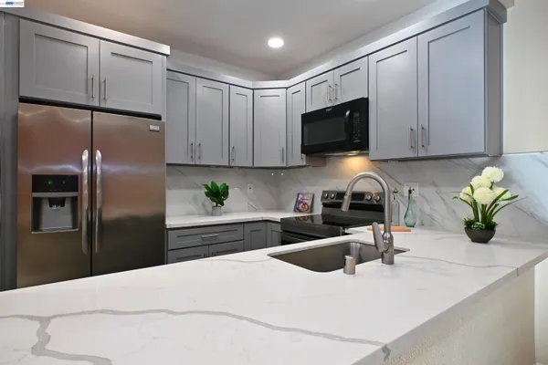 a kitchen with refrigerator and microwave
