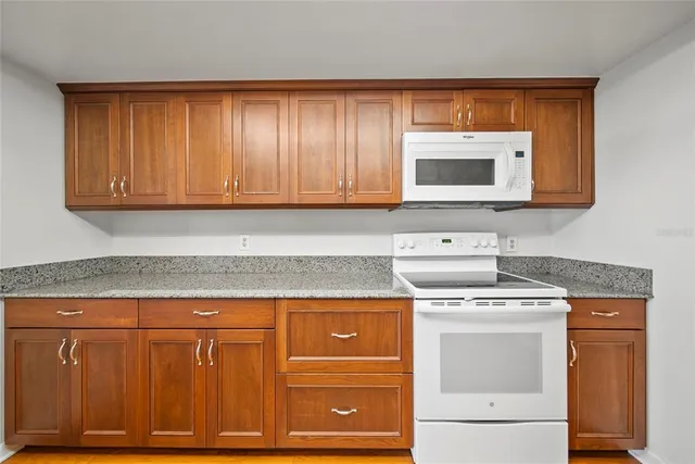 a kitchen with stainless steel appliances granite countertop a sink and stove top oven