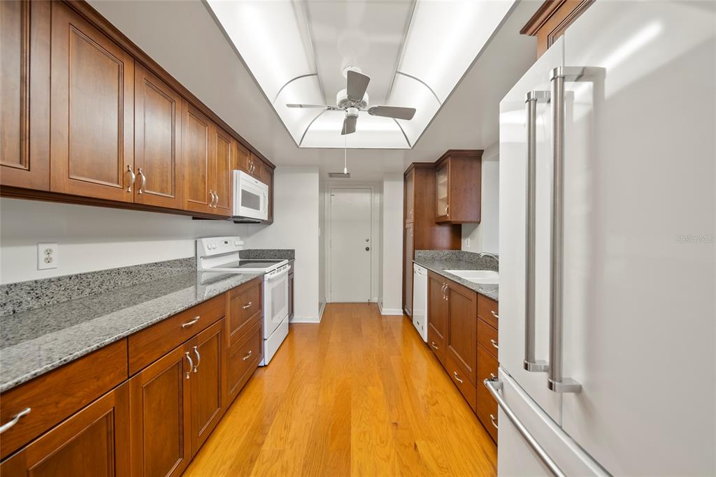 2611 Bayshore Boulevard, Unit 504 Tampa, FL 33629 - Photo 14 of 39 a large kitchen with stainless steel appliances granite countertop a large counter top a stove and a refrigerator