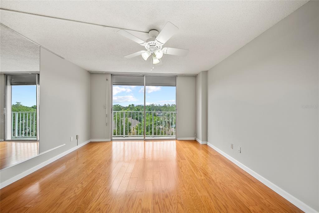 2611 Bayshore Boulevard, Unit 504 Tampa, FL 33629 - Photo 16 of 39 an empty room with wooden floor and windows
