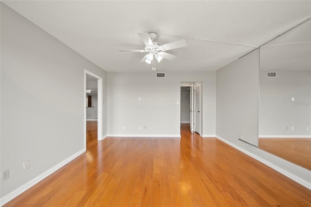 2611 Bayshore Boulevard, Unit 504 Tampa, FL 33629 - Photo 17 of 39 a view of an empty room with chandelier fan and wooden floor