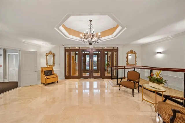 a hallway with mirror and furniture