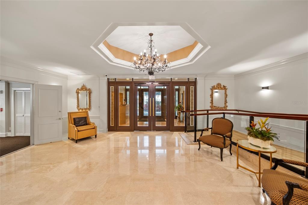 2611 Bayshore Boulevard, Unit 504 Tampa, FL 33629 - Photo 3 of 39 a living room with furniture and a chandelier